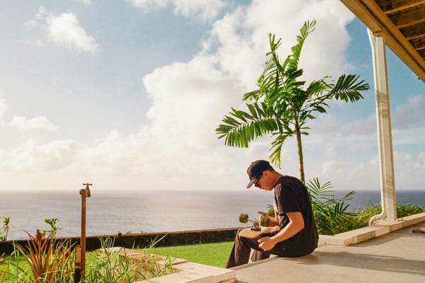 Man sitting on a porch overlooking the ocean
